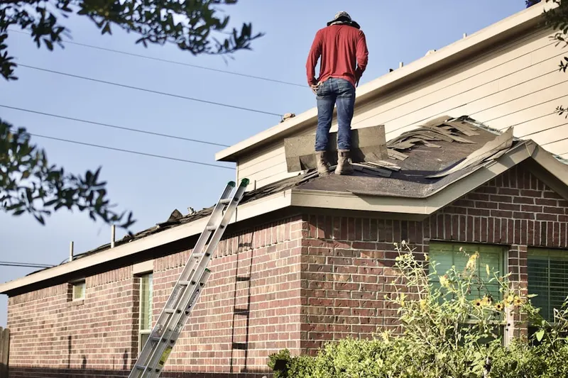Professional roofer working on a residential roof in Park West